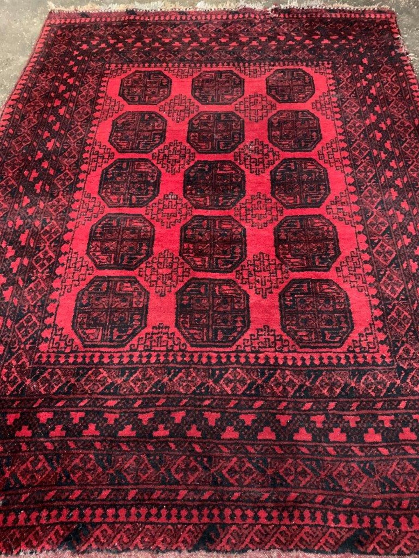 Wool pile red ground Afghan carpet.