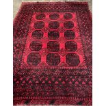 Wool pile red ground Afghan carpet.