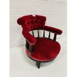 Red velvet upholstered rail backed tub open armchair on casters.