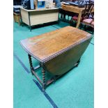 Oak dropside gate leg table with barley twist legs.