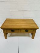 Oak low table with two double-sided frieze drawers, with slatted sides.