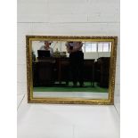 Bevelled edge wall mirror with gilt surround.