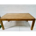 Oak laminate table on block supports.