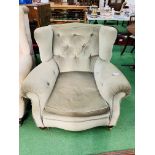 A green upholstered Victorian armchair on casters, 100 x 100 x 88cms.