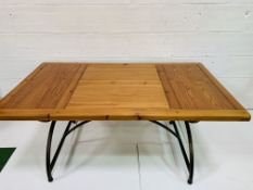 Hardwood table on metal X frame legs with stretcher, together with six matching chairs.