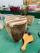 Cowhide bongo drum, set of bellows and a brass lamp on a marble base as found.