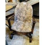 Low oak framed tapestry open arm chair.