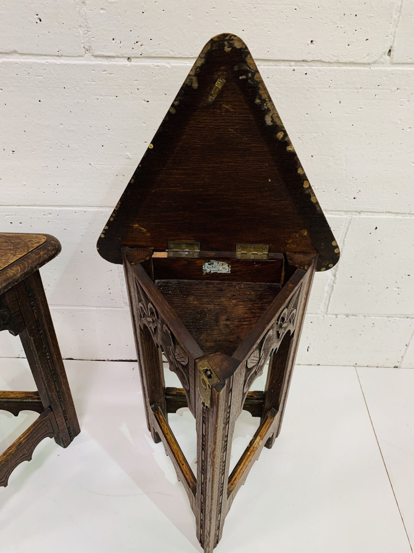 Pair of oak Arts and Crafts triangular stools with lifting lids, carved with fleurs-de-lys. - Image 4 of 4