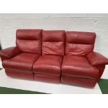 Red leather three seat sofa with reclining ends, and a matching pouffe.