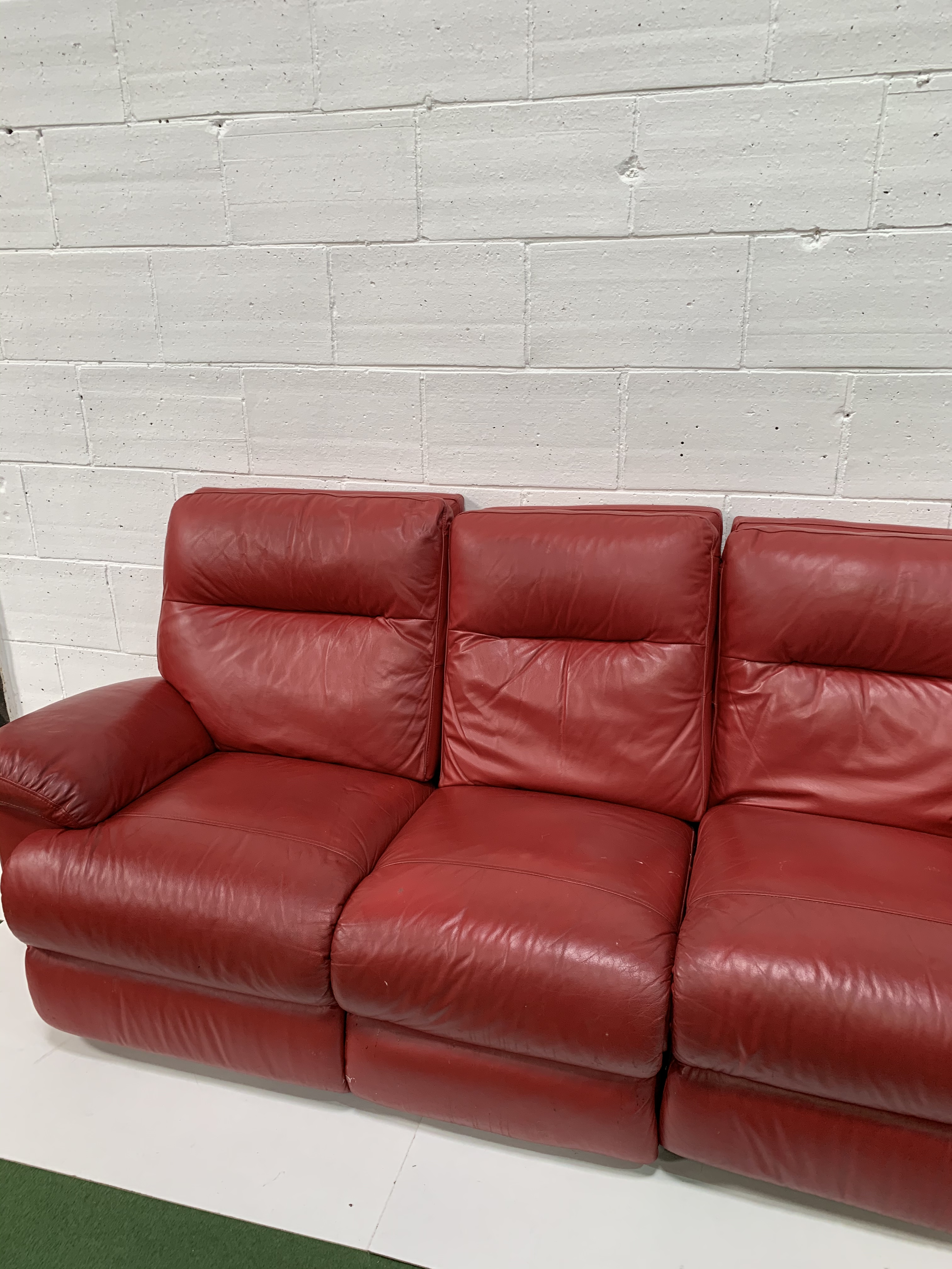 Red leather three seat sofa with reclining ends, and a matching pouffe. - Image 2 of 4