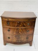 Mahogany bow-fronted chest with three drawers and pull out slide.