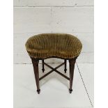 Kidney shape upholstered 4 leg stool on tapered legs