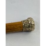 Victorian malacca walking cane, hallmarked silver repousse knob top and brass tip.