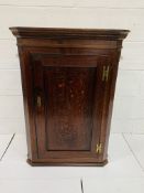 Early 19th century oak wall mounted corner cabinet with three shape-fronted shelves