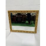 Bevelled edge wall mirror with gilt surround.