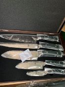 Damascus 5 piece knife set in a case.
