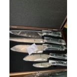 Damascus 5 piece knife set in a case.