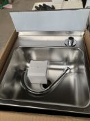 Stainless steel handwash sink and taps.