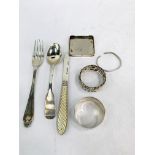 Silver napkin rings, cutlery, and other silver items.