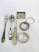 Silver napkin rings, cutlery, and other silver items.