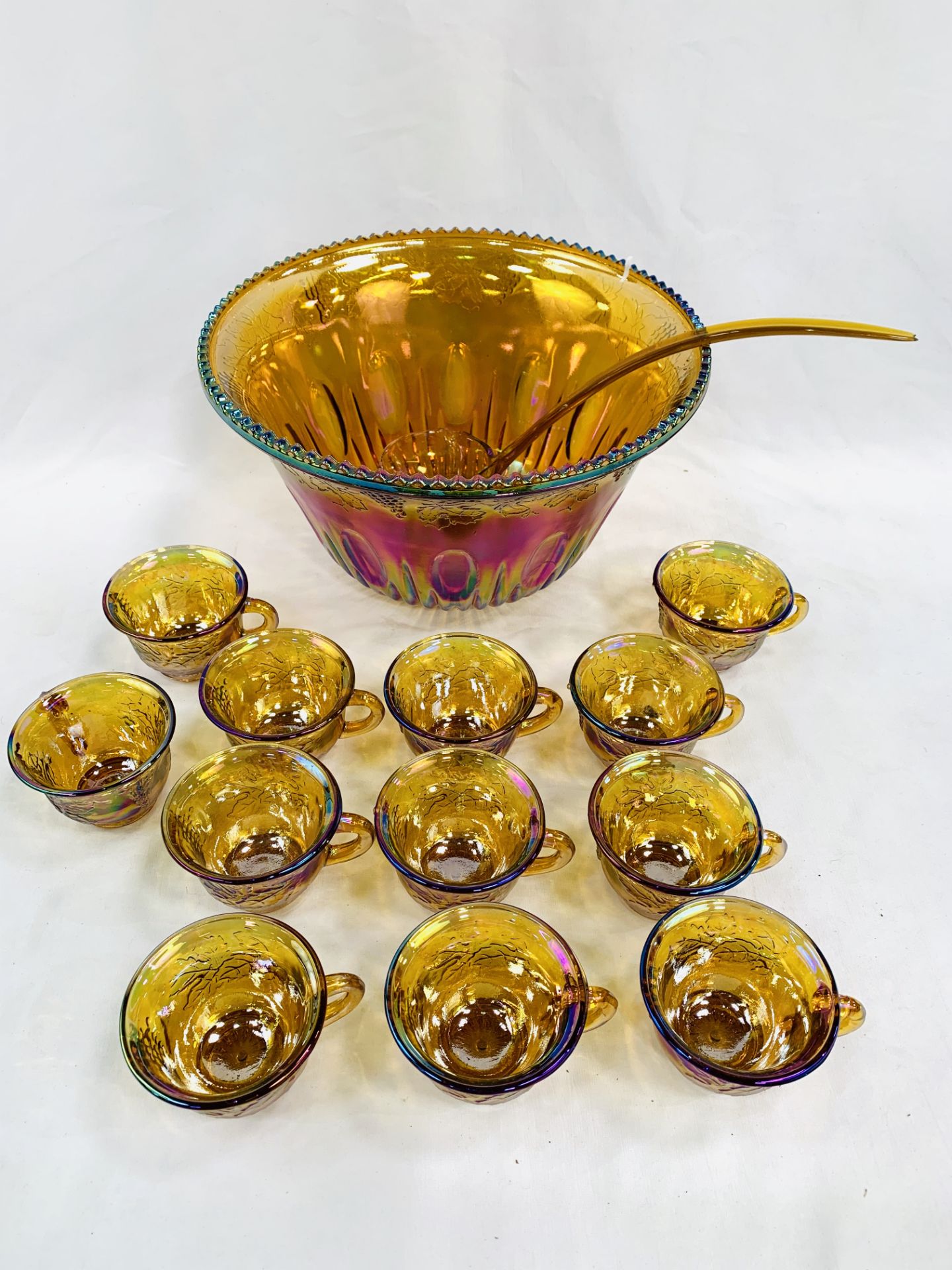 Iridescent glass punch bowl with 12 cups.