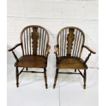 Two oak and elm Windsor style open armchairs with rail backs.