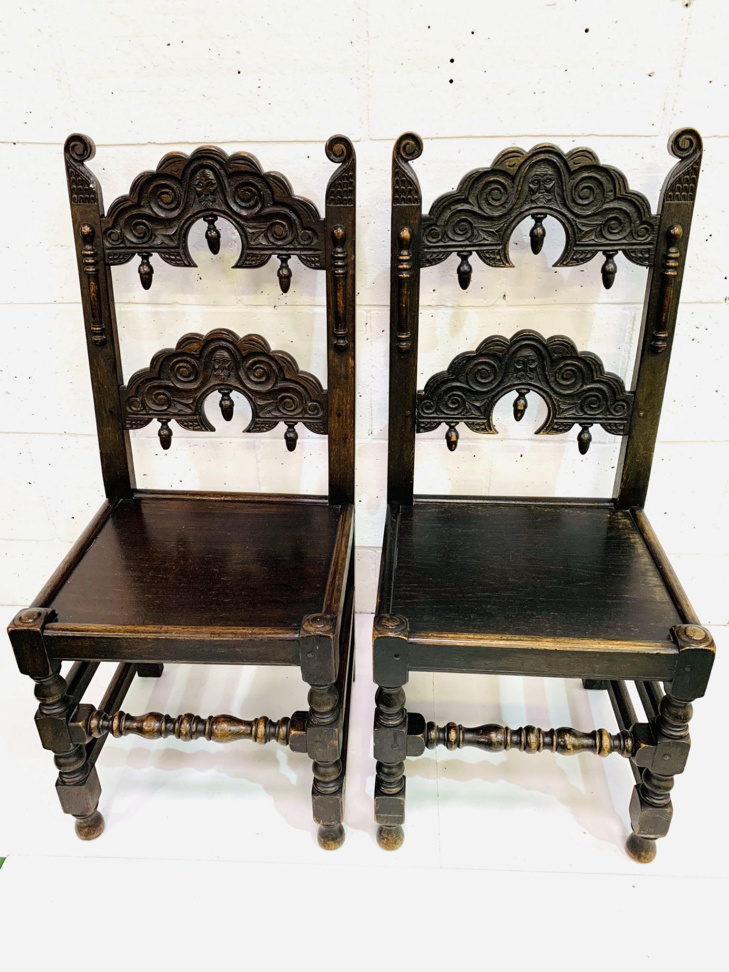 Two oak hall chairs with decorative splats