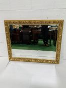 Bevelled edge wall mirror with gilt surround.