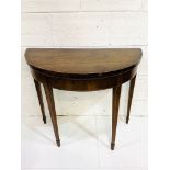 Mahogany demi-lune gate legged card table with scarlet baize, on tapered legs.