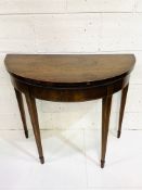 Mahogany demi-lune gate legged card table with scarlet baize, on tapered legs.