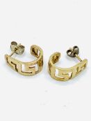 9ct gold contemporary hoop earrings with pierced Greek key relief.