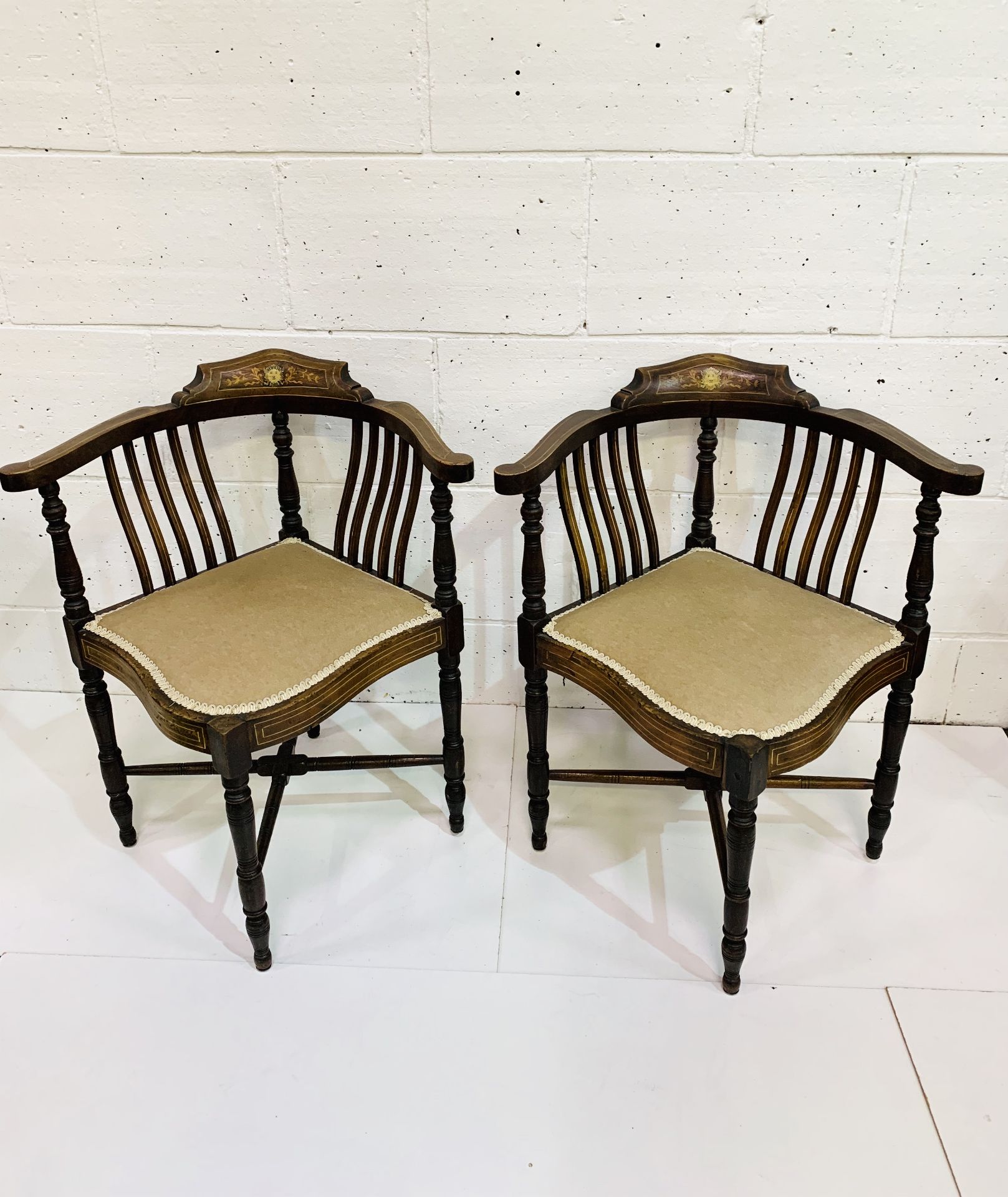 Pair of inlaid mahogany corner chairs with rail backs, upholstered in mushroom fabric.