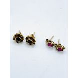 A pair of 9ct garnet earrings and 9ct ruby set earrings.