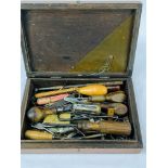 Wooden box containing a quantity of hand tools together with a tin of metal ware including rowelled