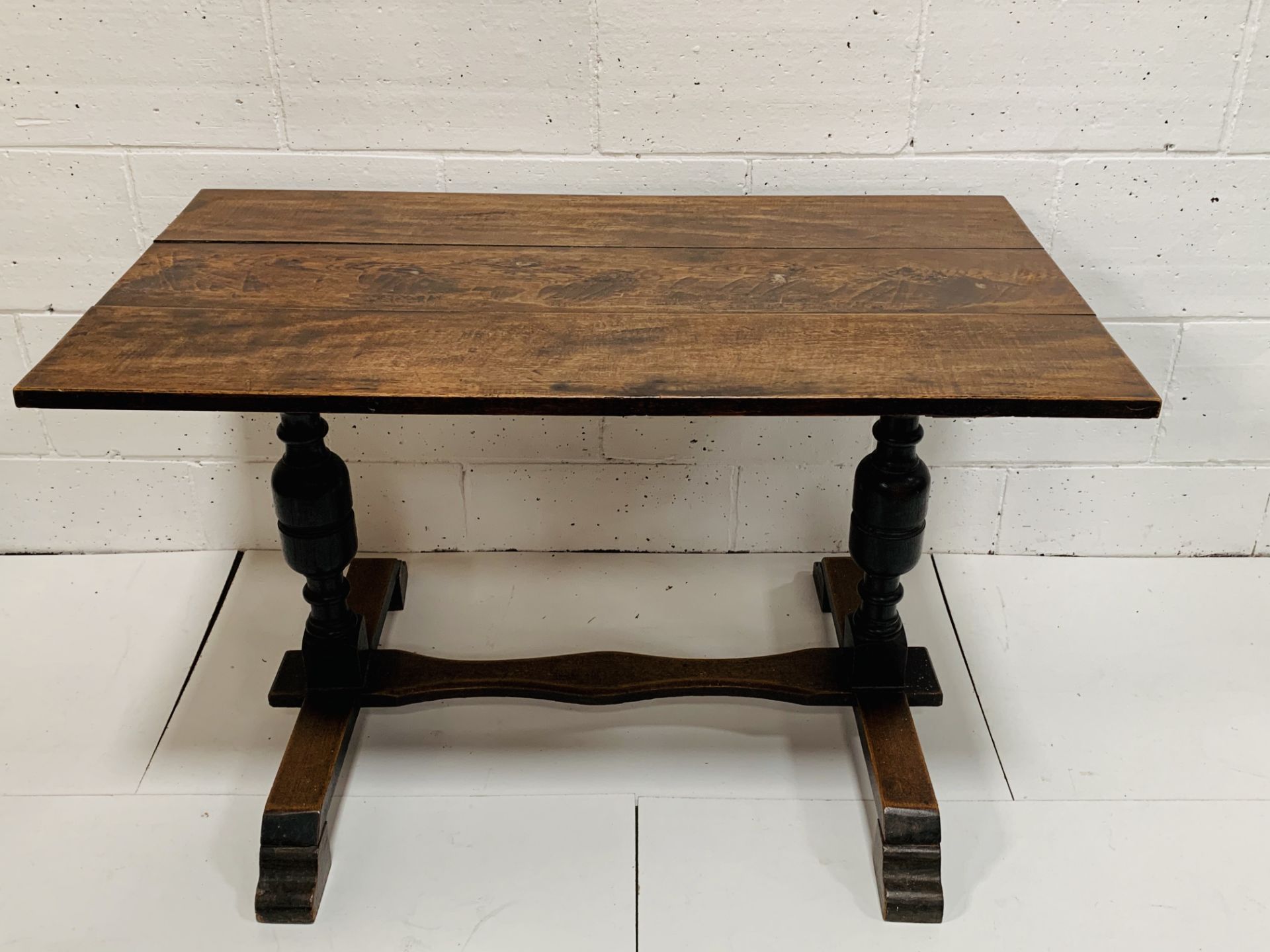 Oak table on bulbous supports with stretcher.