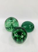 Three green glass End of Day "Dump" weights.