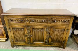 1930's oak sideboard with three frieze drawers over three cupboards.