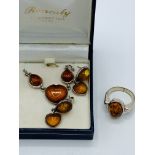 Silver-mounted amber necklace, earrings and ring set.