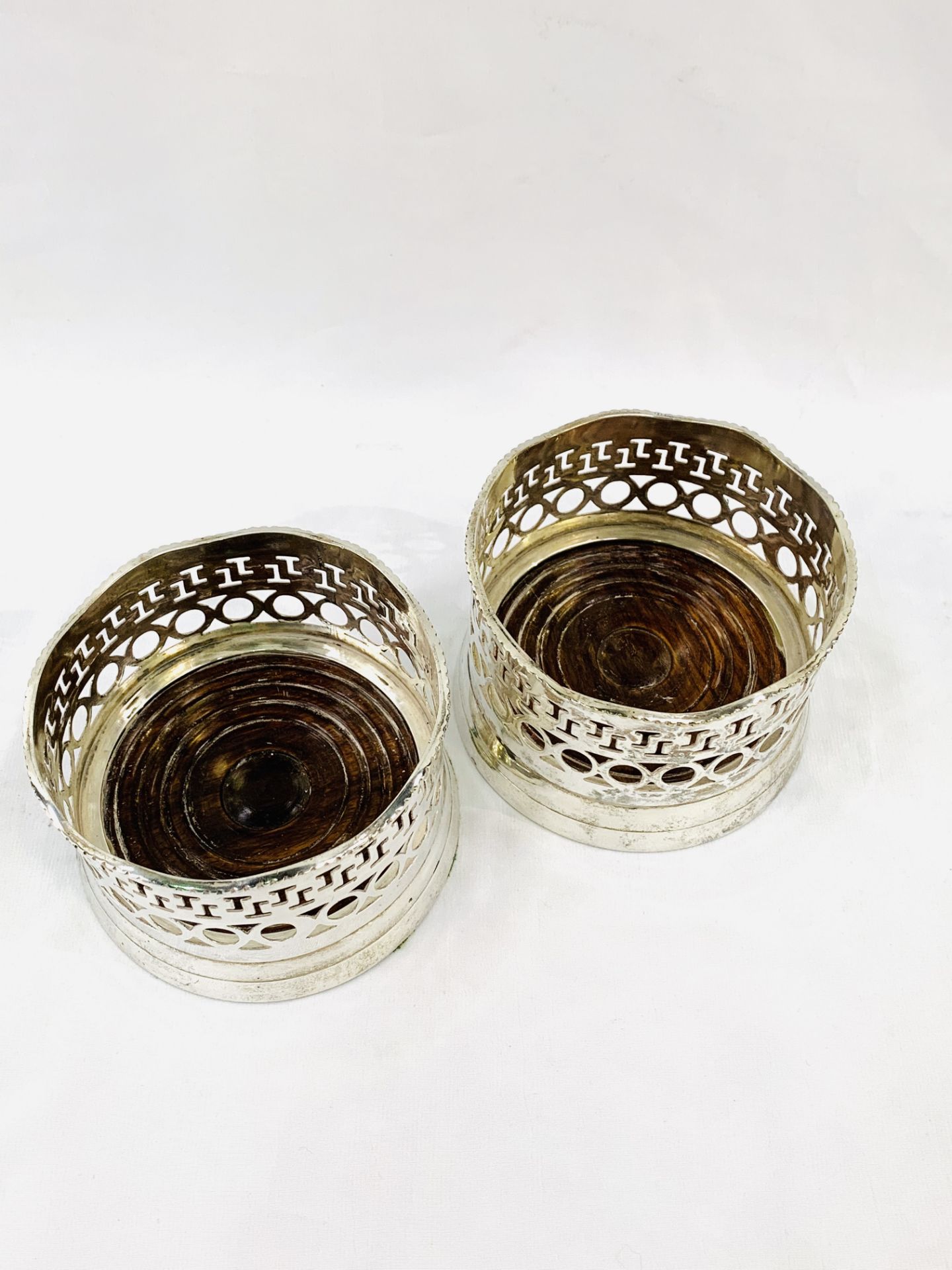 Two Victorian-style silver plate wine bottle coasters with mahogany bases. - Image 2 of 2