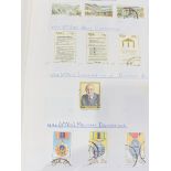 A large quantity in a black tray of world stamps on pages.