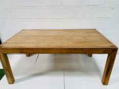 Oak laminate table on block supports.