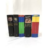 Four Harry Potter first editions and one other.