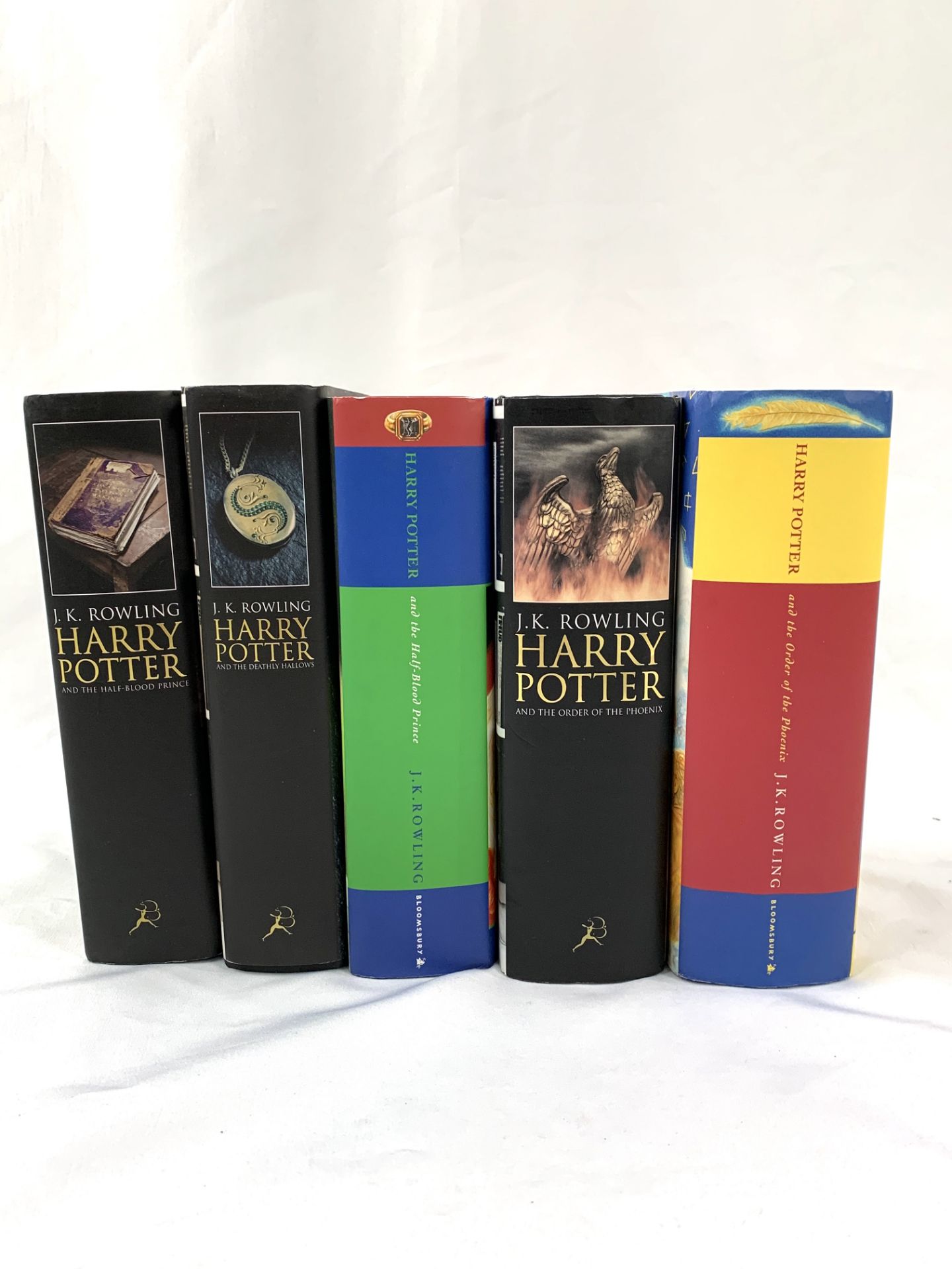 Four Harry Potter first editions and one other.