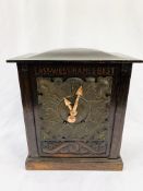 Oak cased mantel clock with copper face carved to face "East, West, Hames Best" by D. C. Co.