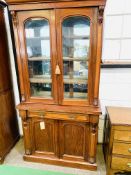 Mahogany bookcase with two glazed doors to three shelves (mirrors to back added) over frieze drawer