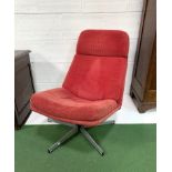 Low swivel lounge chair upholstered in red cord.
