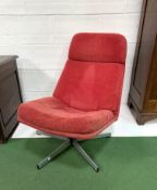 Low swivel lounge chair upholstered in red cord.