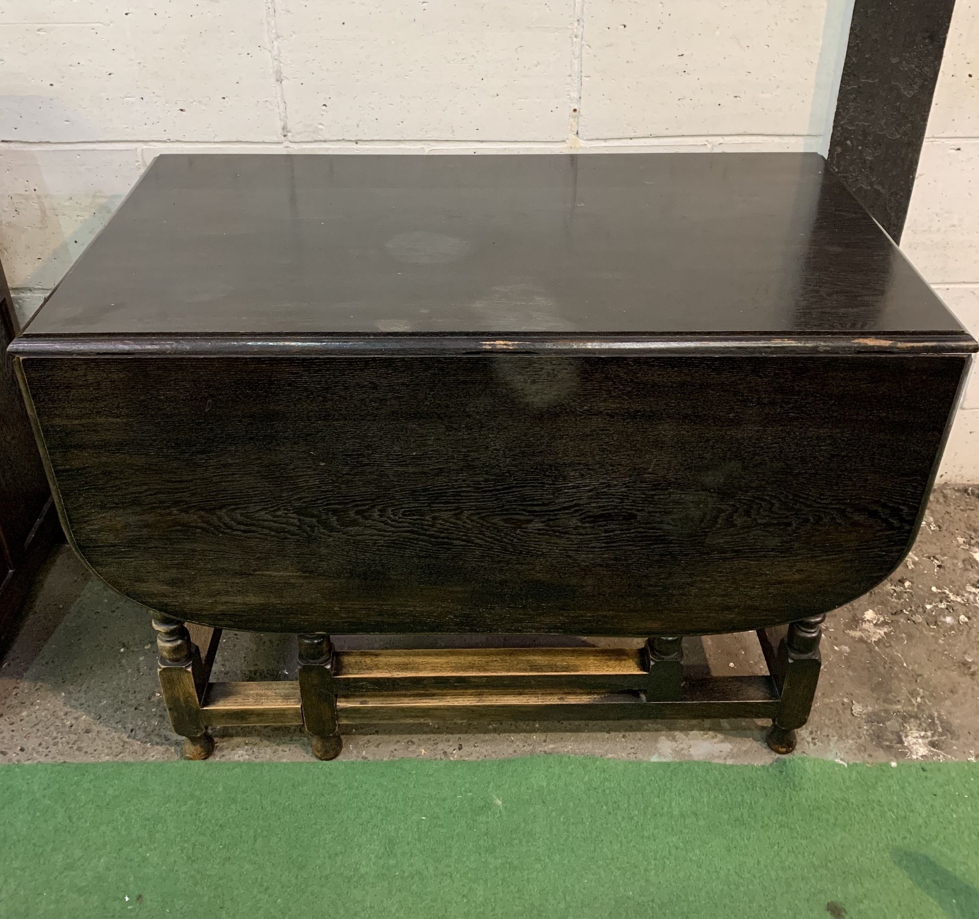 Oak gate leg drop side table with end drawer.