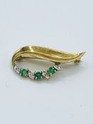 9ct diamond and emerald brooch in a leaf design, length 3cms.