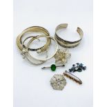 5 silver brooches and five silver bangles.